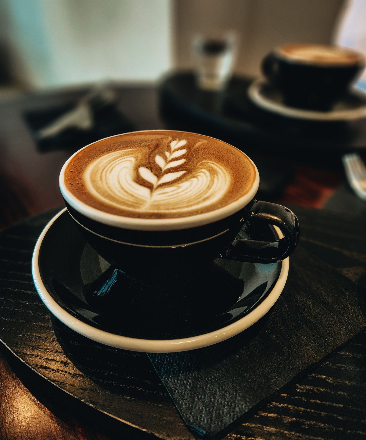 Latte art in a black ceramic cup